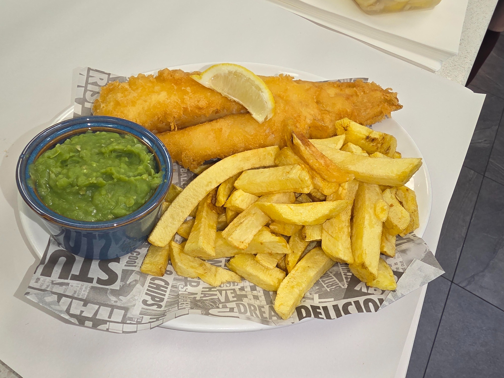 Britz battered fish with golden chips, mushy peas and lemon